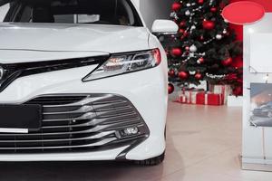 New shining beautiful cars stand near desk reception in car shop photo