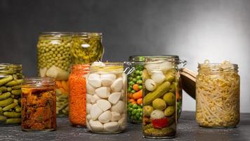 front view assortment vegetables pickled clear glass jars. High quality beautiful photo concept