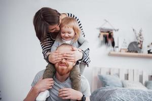 Happy family mother, father and child daughter at home photo