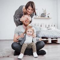 Happy family mother, father and child daughter at home photo