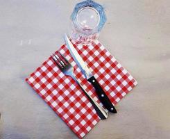 cutlery and napkin on a table in a fish restaurant on the Ligurian Riviera on a summer evening photo