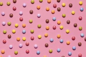 full frame colorful multicolored gem candies pink background