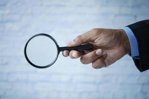 businessmen hand hold a magnifying glass photo