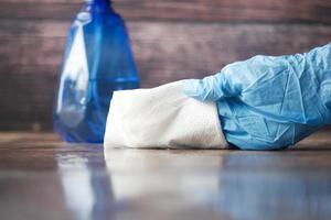 close up of person hand cleaning table with cloth photo