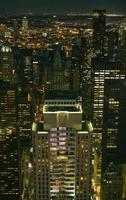 Skyscrapers windows illuminated at night in Manhattan photo