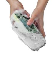 Woman hand washing dishware on white background photo
