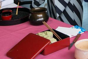 Red metal box with japanese cakes for the tea ceremony photo