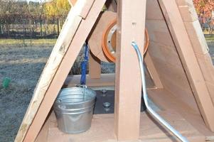 Wooden house for drinking water well photo