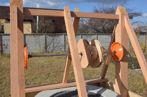 Wooden house for drinking water well photo