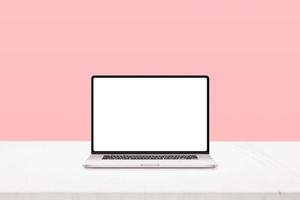 Laptop mockup on white desk with pastel pink background photo