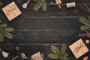 Chrismtas composition on wooden table. Top view, flat lay scene with copy space in the middle for greeting text photo