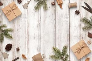 Rustic Christmas composition on white wooden table. Top view, flat lay scene with copy space in middle photo