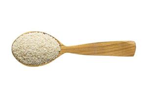 sesame seed in wooden spoon isolated on white background