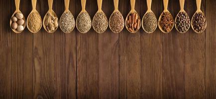 collection of Indian spices and herbs on wooden table photo