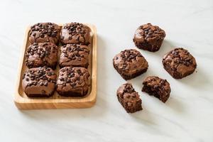 dark chocolate brownies topped by chocolate chips photo