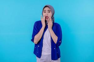 Surprised happy girl wearing hijab react to wonderful news, scream from rejoice photo