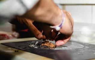 Making Vietnamese traditional spring rolls by hands in a restaurant photo