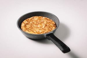 tortilla de patatas on white background, typical spanish dish photo