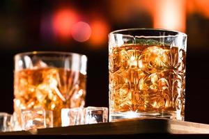 Bebidas de whisky con hielo en un bar salón. foto