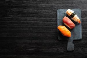 Nigiri sushi on wood table in a japanese restaurant. Copy space and top view photo
