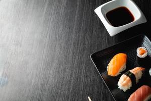 Elegant sushi on wood table. Some Nigiri, with soy sauce and chopstick photo