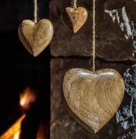 Wooden hearts and old stone fireplace photo