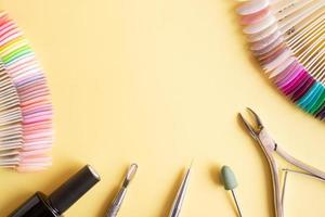 Flat lay manicure tools on a colored background with copy space photo