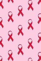 símbolo de patrón de cintas rojas del día mundial del sida sobre fondo rosa foto