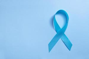 Blue ribbon on blue background symbol of world diabetes day photo