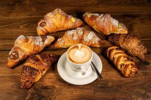 sweet croissants with cream and cappuccino photo