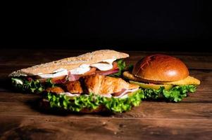 composition of sandwiches with salami and vegetables photo