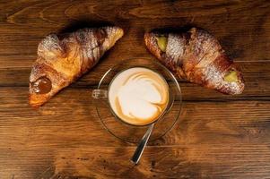 sweet croissants with cream and cappuccino photo