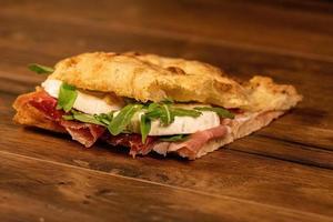 sandwich with salami and vegetables photo