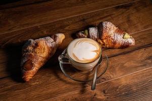 sweet croissants with cream and cappuccino photo