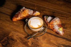 sweet croissants with cream and cappuccino photo