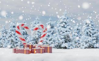 paisaje nevado con bastones de caramelo y regalos. foto