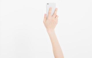 Hand holding white phone isolated on white clipping path inside. Top view.Mock up.Copy space.Template.Blank. photo