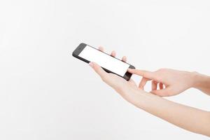 Girl holding black phone. Cellular isolated on white clipping path inside. Top view.Mock up.Copy space.Template.Blank. photo