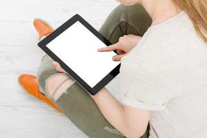 Girl sitting with tablet in hands.Top view.Mock up.Copy space.Template.Blank. photo