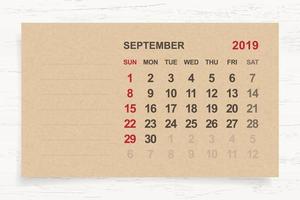 September 2019 - Monthly calendar on brown paper and wood background with area for note. Vector. vector