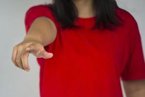 A beautiful young girl pinting with her index finger photo