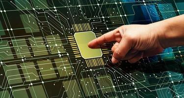 Right hand pointing at a computer chip. Electrical diagram. Integrated circuit. photo