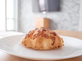 Croissant bread on white dish in the morning. photo