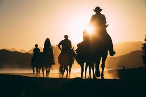 Horseback riding at sunset photo
