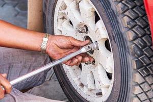 Mechanic Replacing wheel. photo