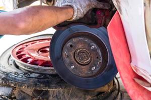 Mechanic Replacing brakes. photo