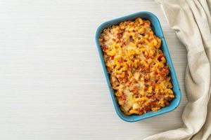 homemade macaroni bolognese with cheese photo