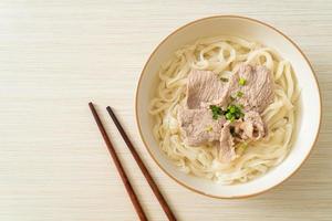 udon noodles with pork in clear soup photo