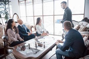 Young team of coworkers making great business discussion in modern office. Teamwork people concept photo