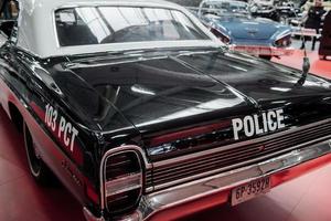 SINSHEIM, GERMANY - OCTOBER 16, 2018 Technik Museum. Backing part of the police car that standing on white tile at vehicle exhibition photo